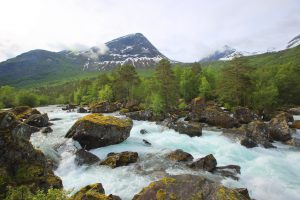 Beautiful spring Norway landscape with river rapids and mountains